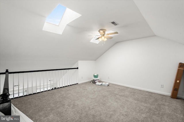 bonus room featuring carpet, vaulted ceiling with skylight, and ceiling fan