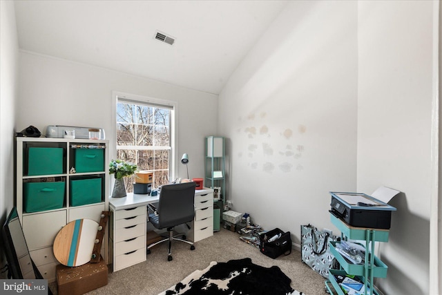 carpeted office with lofted ceiling