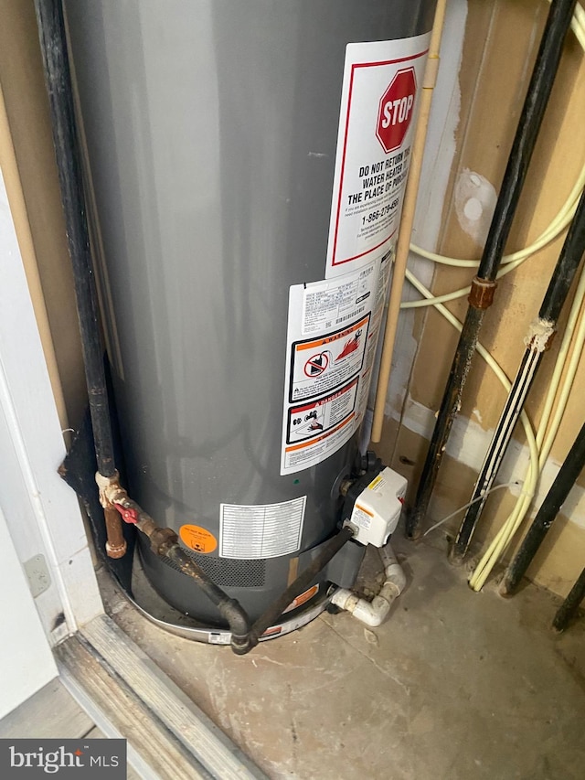 utility room featuring water heater