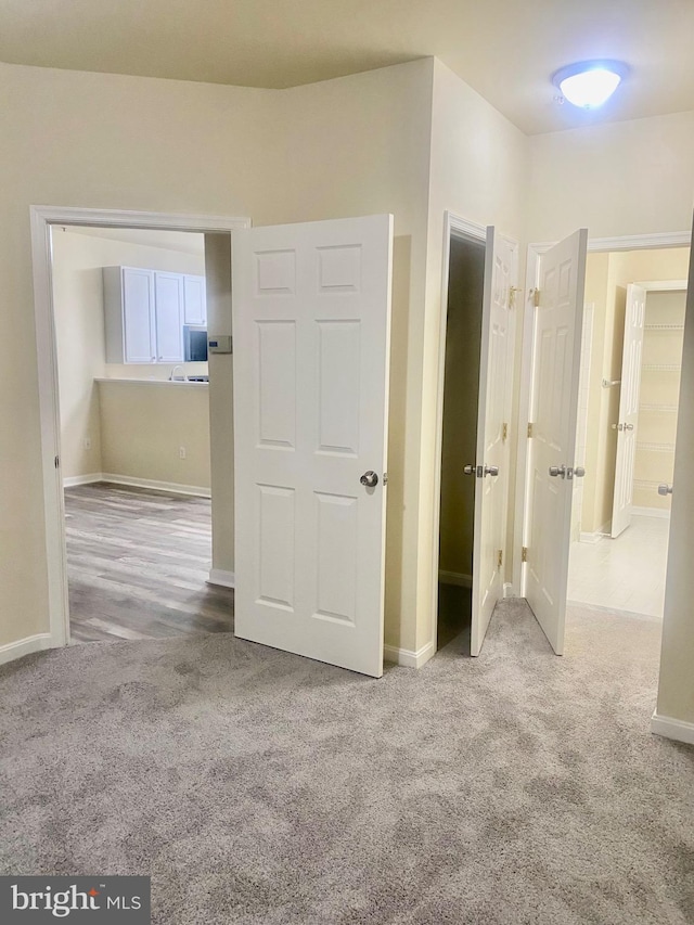 unfurnished bedroom with light carpet