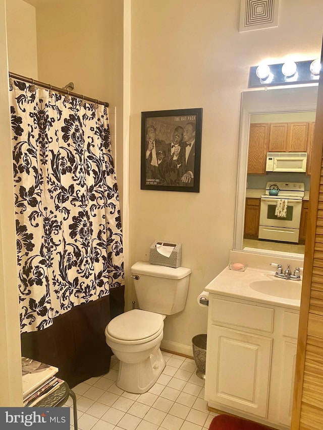 bathroom with tile patterned flooring, a shower with curtain, vanity, and toilet