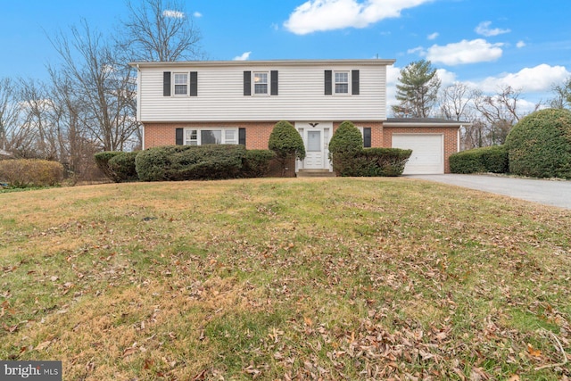 front facade featuring a front lawn and a garage