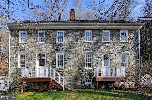 back of house featuring a wooden deck