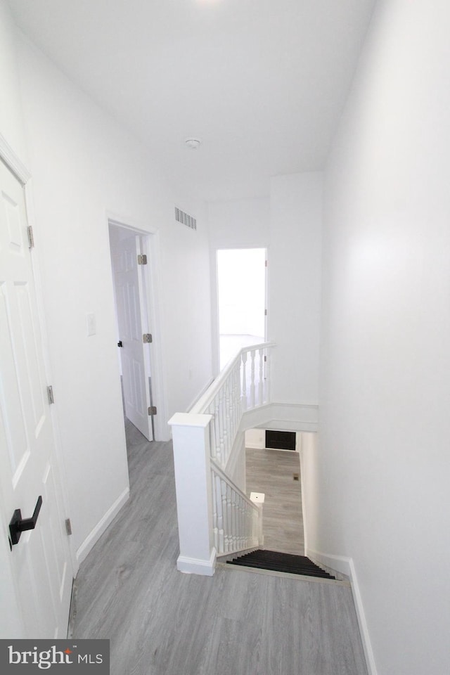 corridor with light hardwood / wood-style flooring