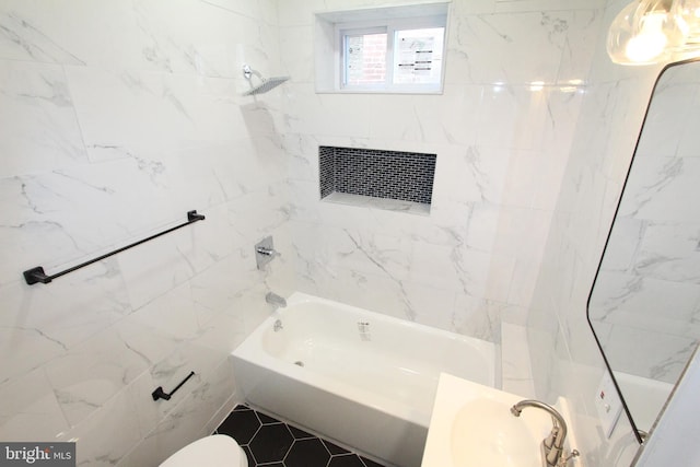 bathroom with tile patterned flooring, tiled shower / bath combo, and toilet