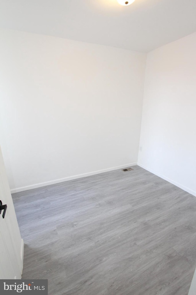 empty room featuring dark hardwood / wood-style flooring