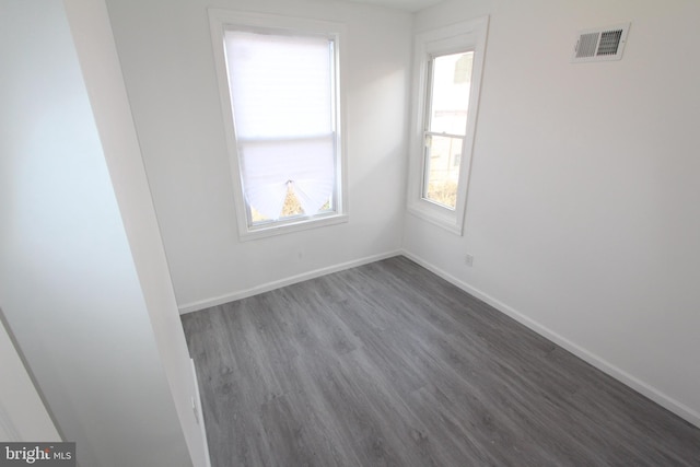 spare room featuring dark wood-type flooring