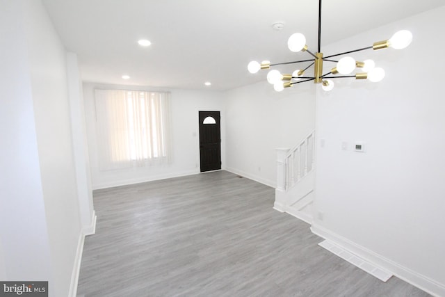 interior space featuring a chandelier and hardwood / wood-style floors