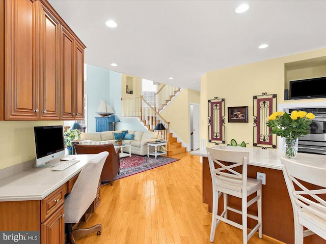 office space featuring built in desk and light hardwood / wood-style floors