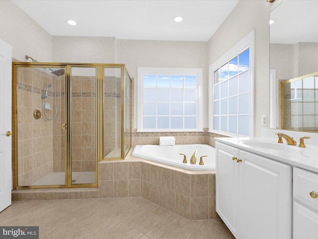 bathroom with shower with separate bathtub, vanity, and tile patterned flooring