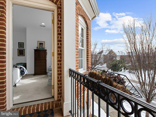 view of snow covered back of property