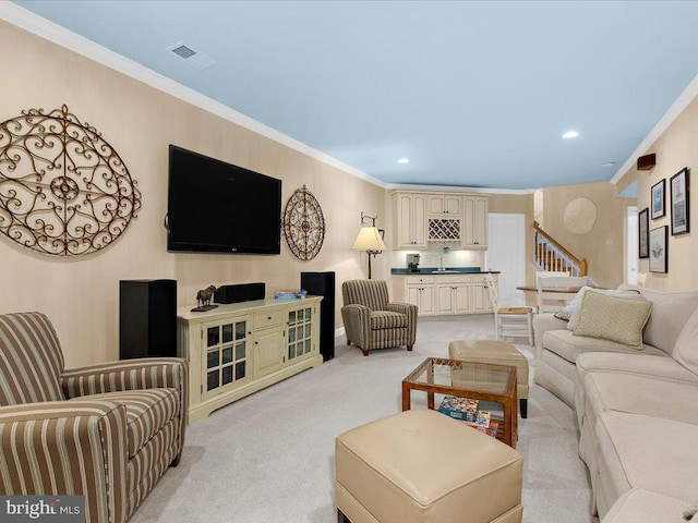 living room featuring light colored carpet, ornamental molding, and sink