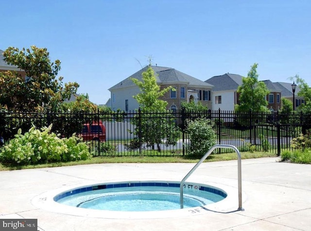 view of swimming pool with a community hot tub