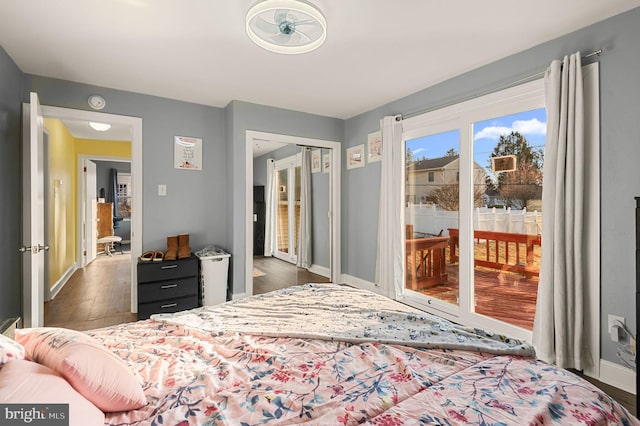 bedroom featuring access to outside and dark wood-type flooring