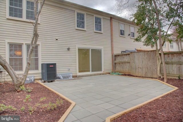 rear view of house featuring a patio and central AC