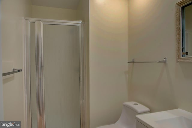 bathroom with vanity, an enclosed shower, and toilet