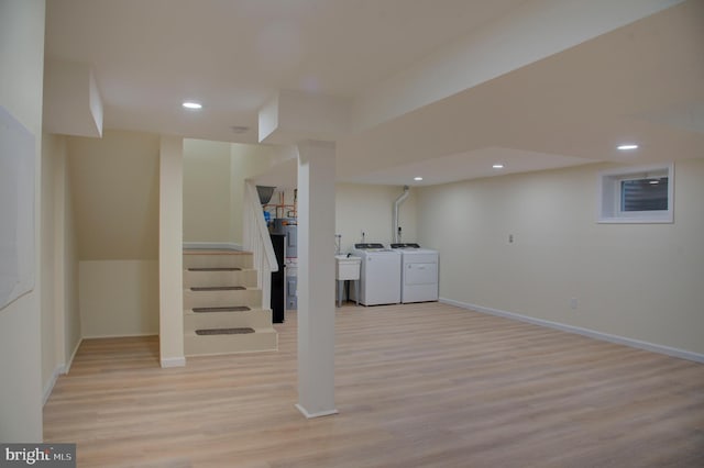 basement with separate washer and dryer and light hardwood / wood-style flooring