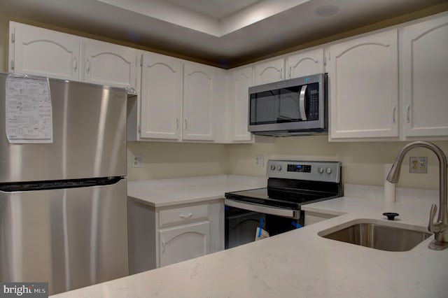 kitchen with white cabinets, sink, and stainless steel appliances