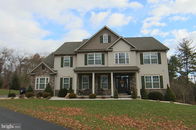 craftsman-style home featuring a front lawn