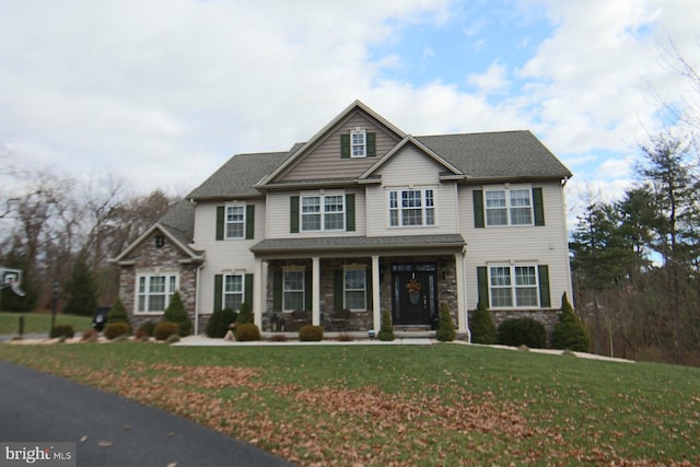 view of front of property featuring a front lawn and covered porch