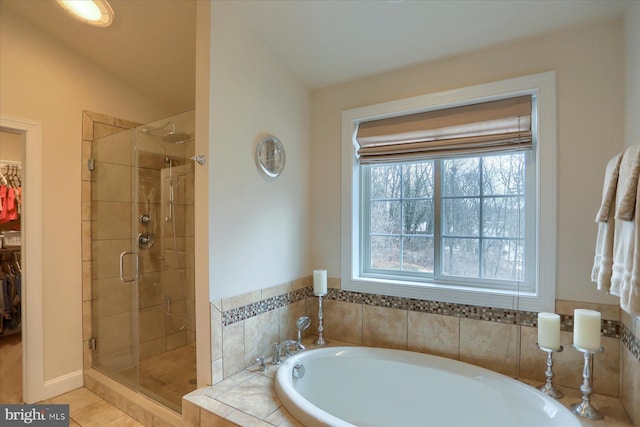 bathroom featuring tile patterned flooring, shower with separate bathtub, and vaulted ceiling