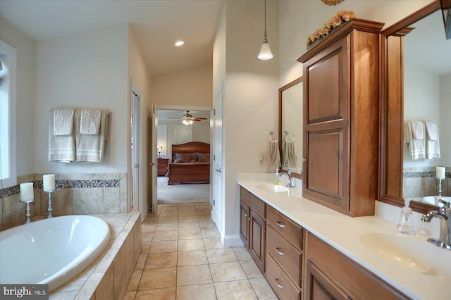 bathroom with vanity, lofted ceiling, tile patterned floors, ceiling fan, and tiled bath