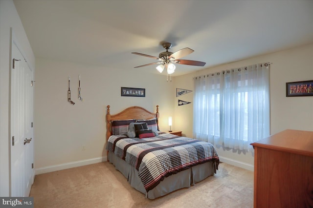 bedroom with ceiling fan and light colored carpet