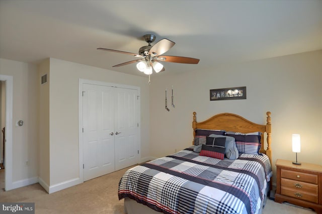 carpeted bedroom featuring a closet and ceiling fan