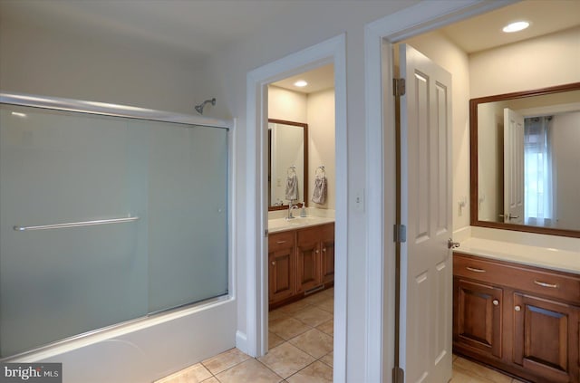 bathroom with tile patterned flooring, vanity, and combined bath / shower with glass door