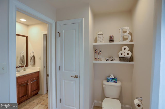 bathroom with tile patterned flooring, vanity, and toilet