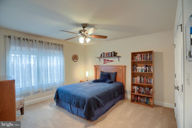 bedroom with light carpet and ceiling fan