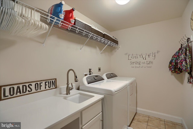 laundry room with cabinets, independent washer and dryer, sink, and light tile patterned floors