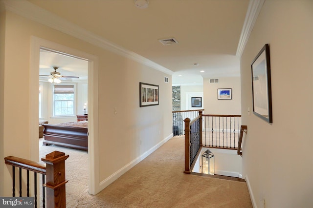 hall with light colored carpet and ornamental molding