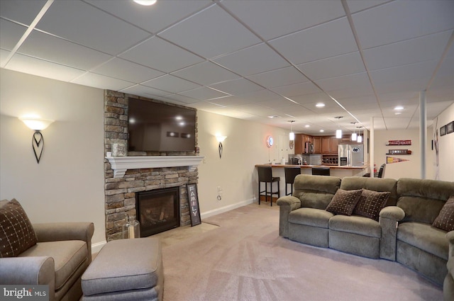 living room with light carpet and a fireplace