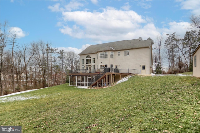 back of house featuring a yard, a deck, and a sunroom