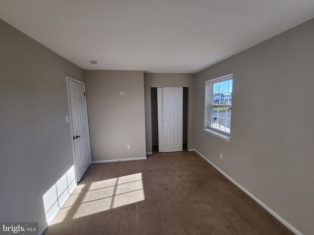 unfurnished bedroom with light colored carpet