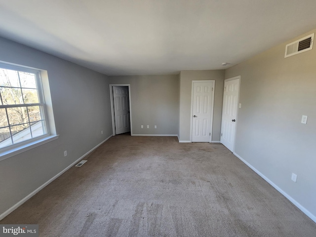 unfurnished room with light carpet