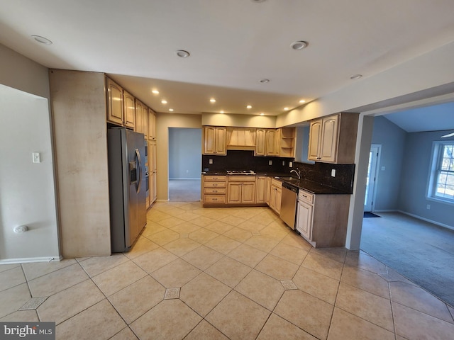 kitchen featuring sink, backsplash, light colored carpet, light brown cabinetry, and appliances with stainless steel finishes