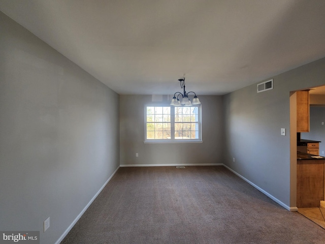 unfurnished dining area featuring carpet flooring and a chandelier