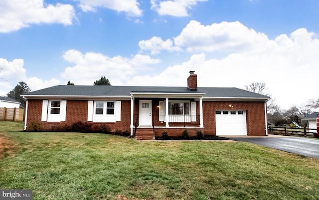 single story home featuring covered porch, a garage, and a front yard