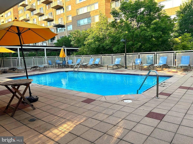 view of swimming pool with a patio