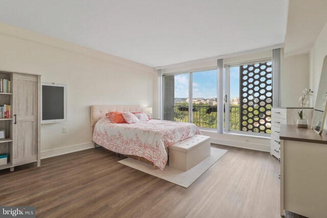 bedroom with dark hardwood / wood-style floors