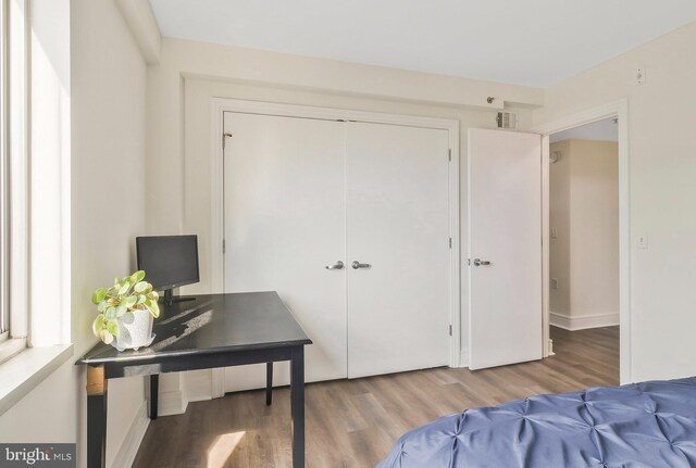 bedroom with hardwood / wood-style floors and a closet