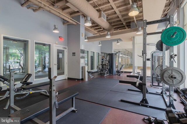 exercise room with a towering ceiling