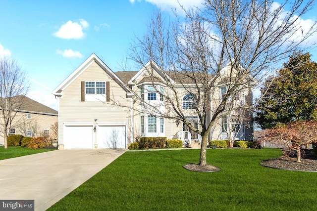 view of front of home with a front yard and a garage