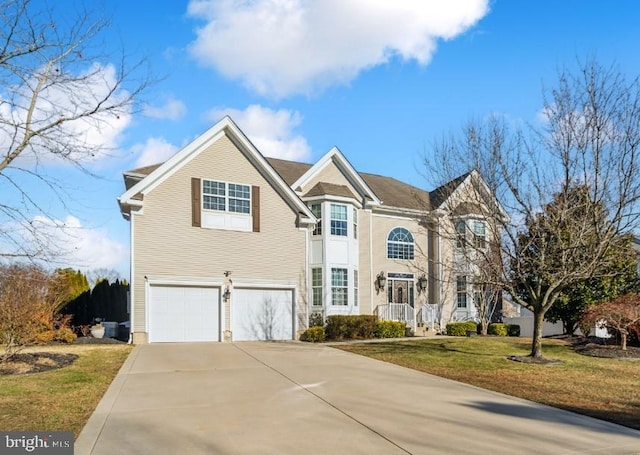 front of property featuring a front lawn and a garage