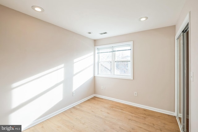 unfurnished bedroom with light wood-type flooring and a closet