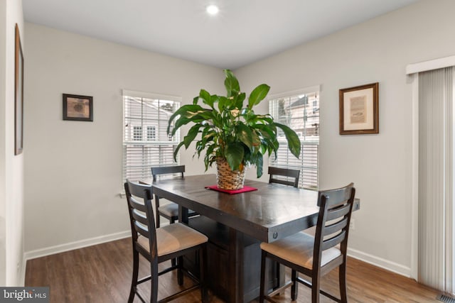 dining room with dark hardwood / wood-style floors