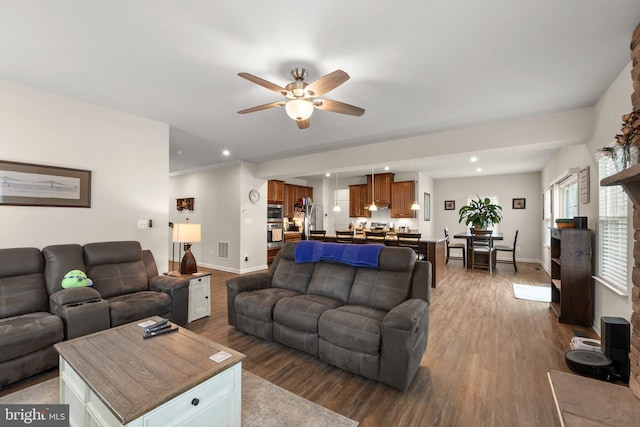 living room featuring hardwood / wood-style flooring and ceiling fan