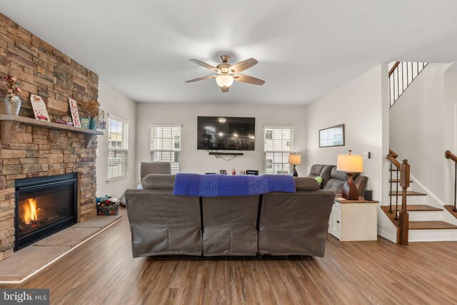 living room with ceiling fan, hardwood / wood-style floors, and a fireplace